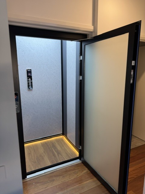 Electric home elevator with dark finish