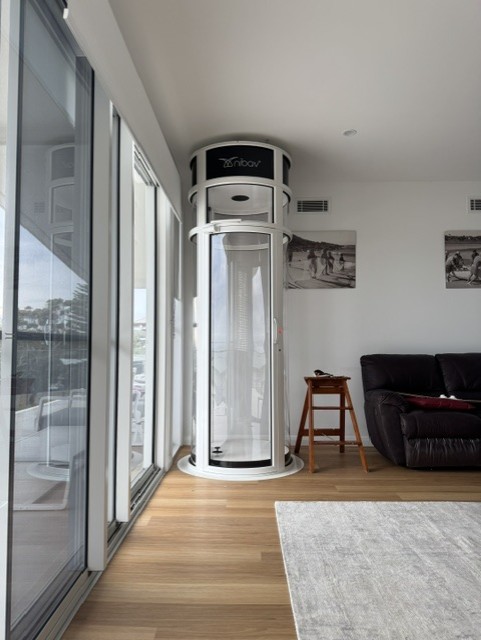 Modern glass home elevator in living space